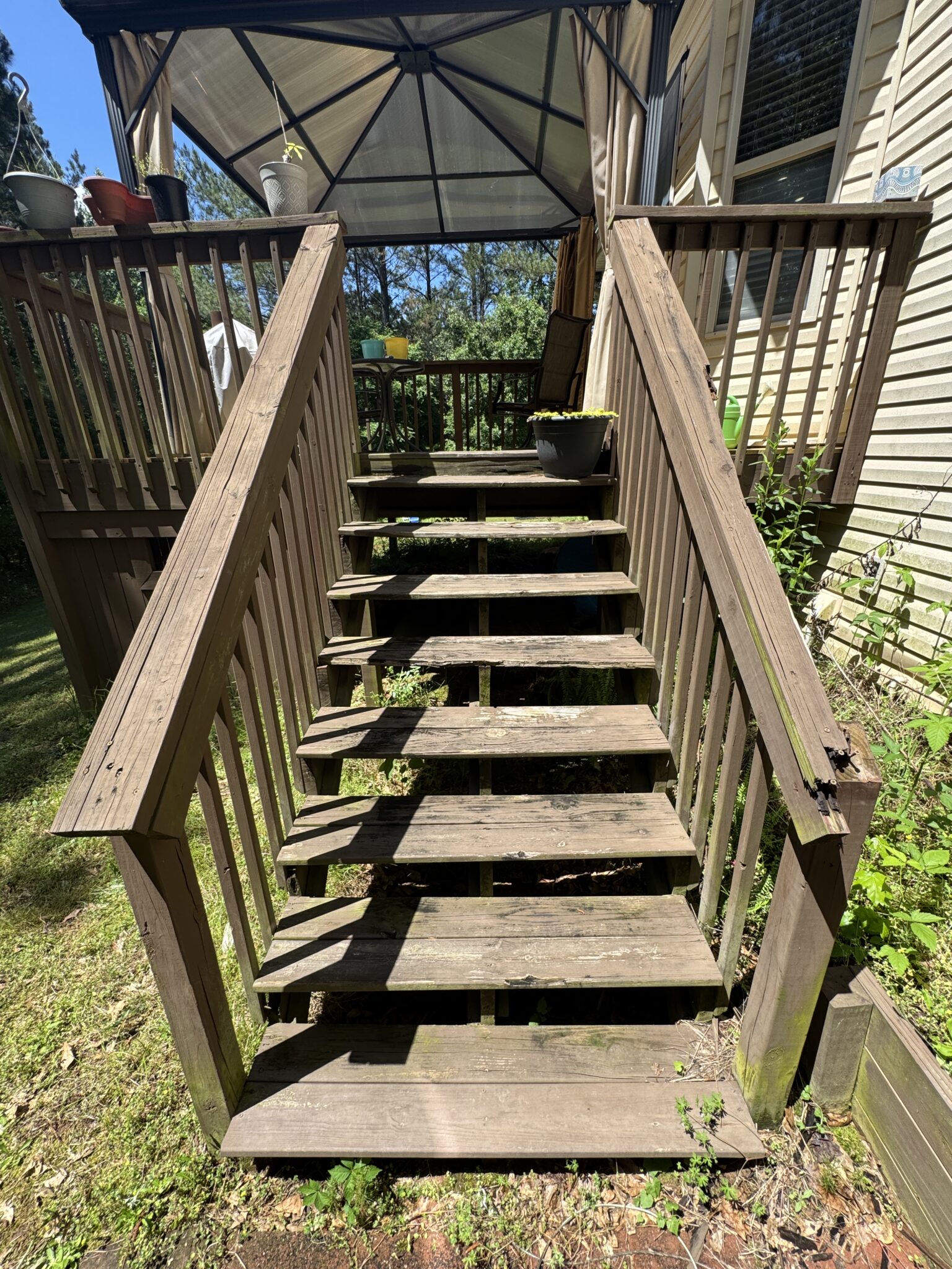 Outdoor deck stairs built with sturdy wooden railings for backyard access